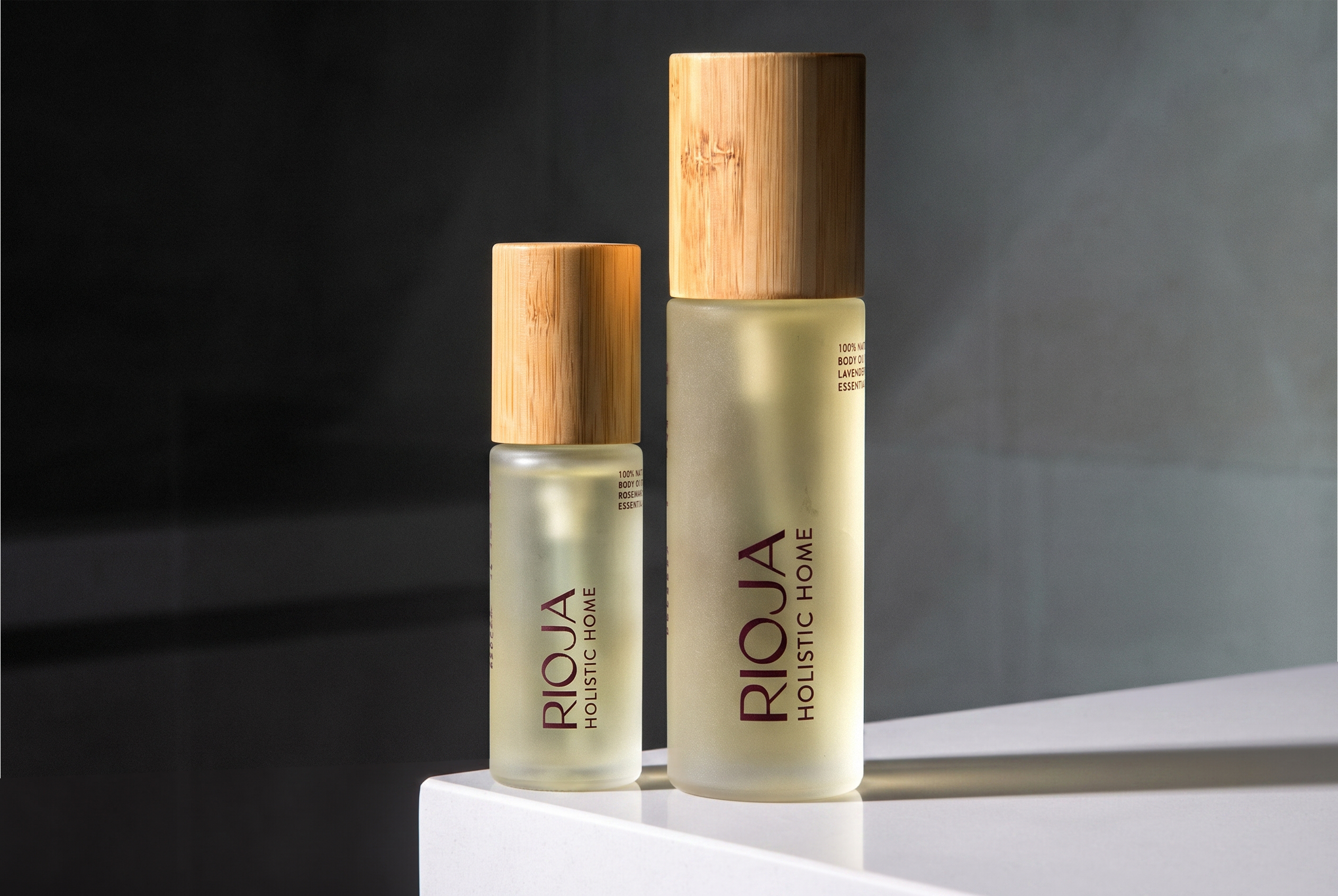 Lavender and Rosemary Body oil bottles with wooden cap on a dark background by Rioja Holistic Home