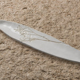 White ceramic Blanco Tray with floral design on a sandy surface