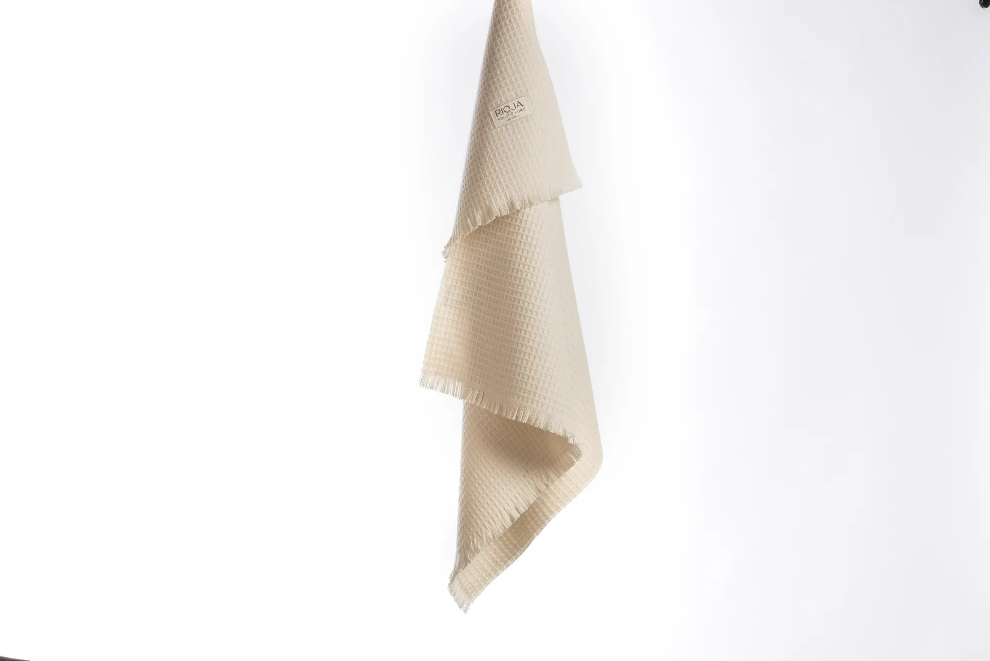 Beige 100% merino wool baby blanket with a subtle pattern on a white background