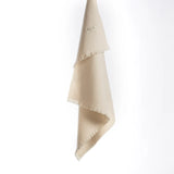 Beige 100% merino wool baby blanket with a subtle pattern on a white background