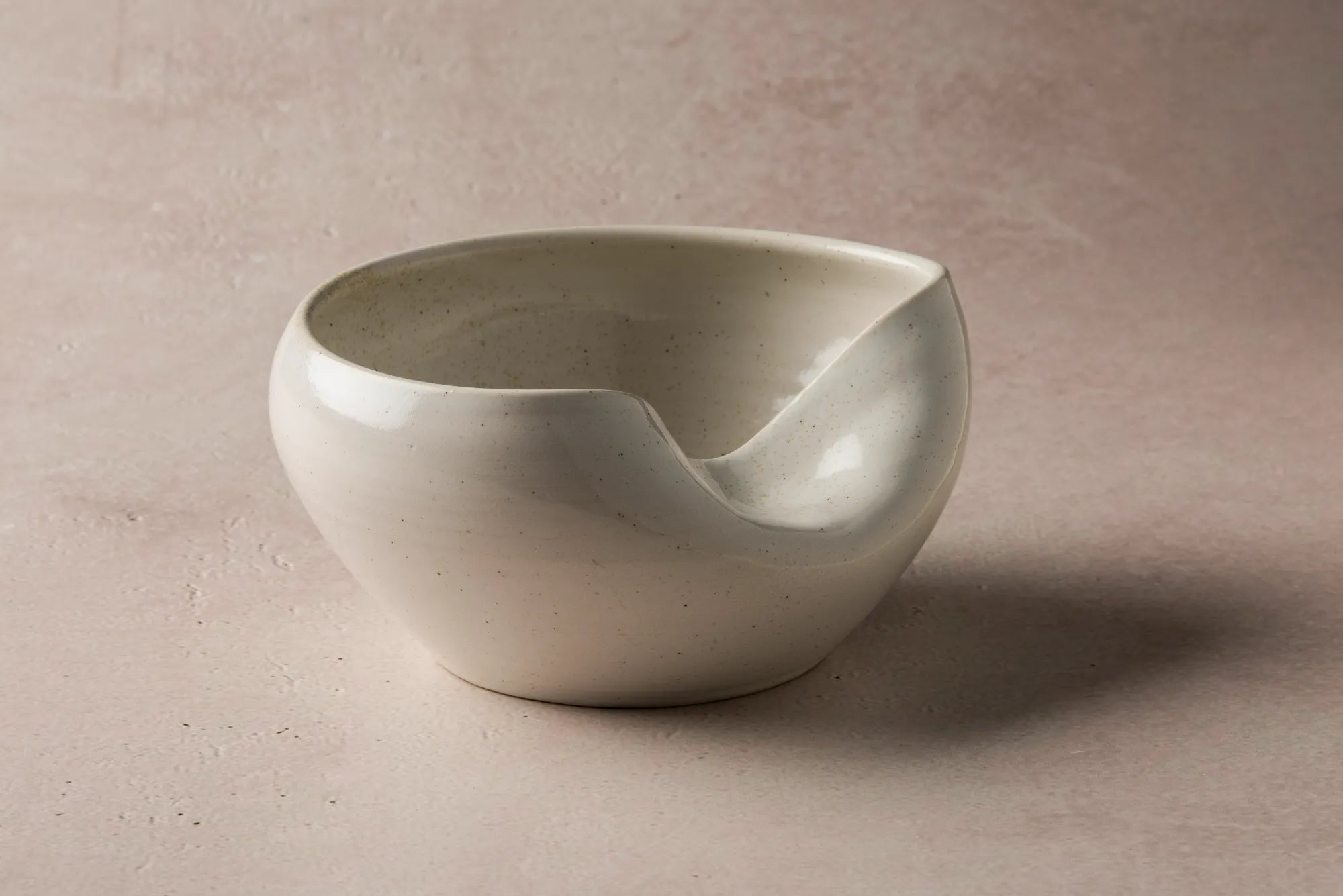 White ceramic Cuenko bowl on a beige background