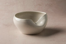 White ceramic Cuenko bowl on a beige background