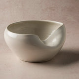 White ceramic Cuenko bowl on a beige background