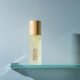 Rioja Holistic Home body oil labeled on a glass shelf with a light blue background