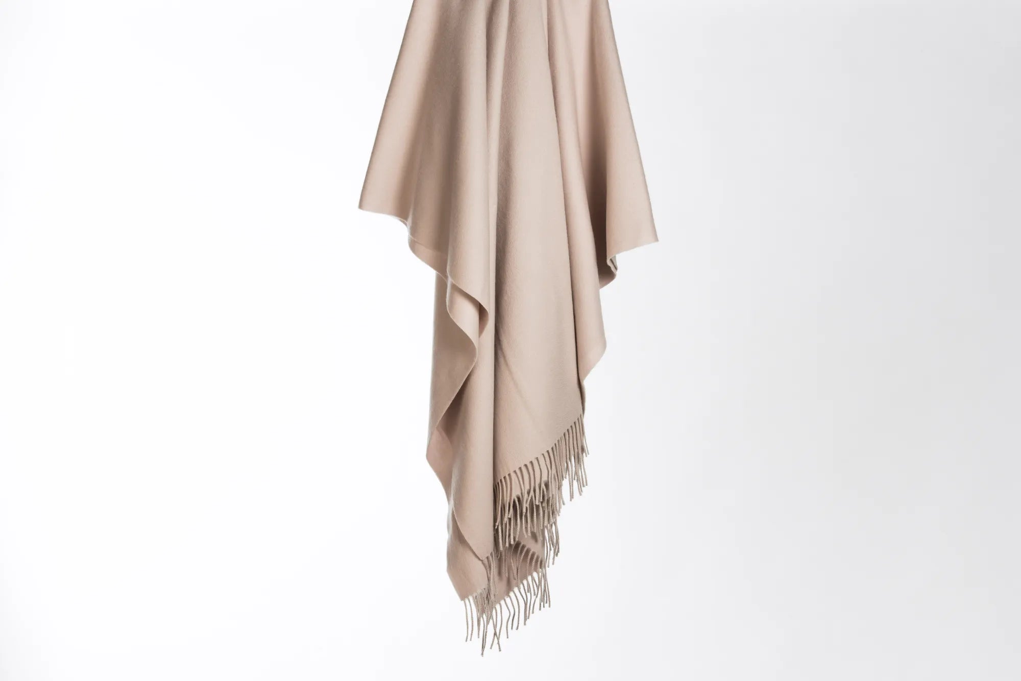 Beige 100% merino wool blanket with fringes on a white background