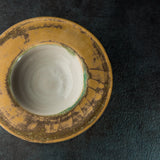 Ceramic Sombrero bowl with a textured yellow rim on a dark surface