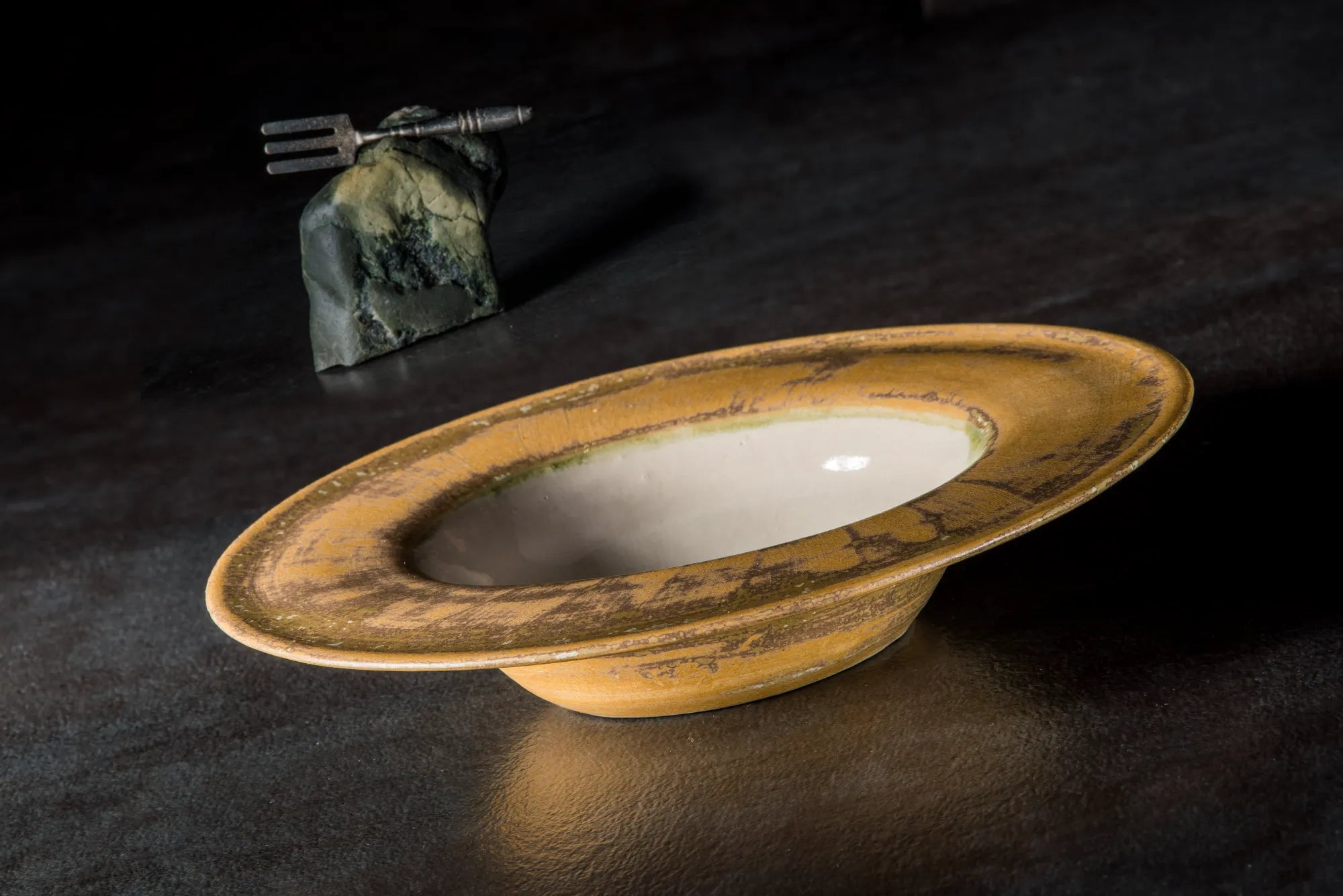 Decorative Sombrero bowl with a rustic finish on a dark surface