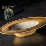 Decorative Sombrero bowl with a rustic finish on a dark surface